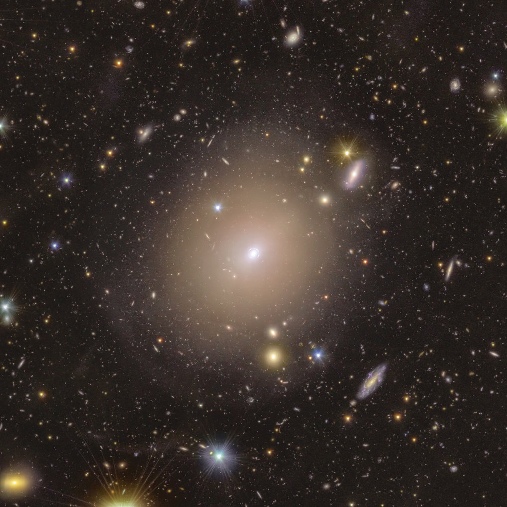 Galaxy cluster in space with shining stars and galaxies.